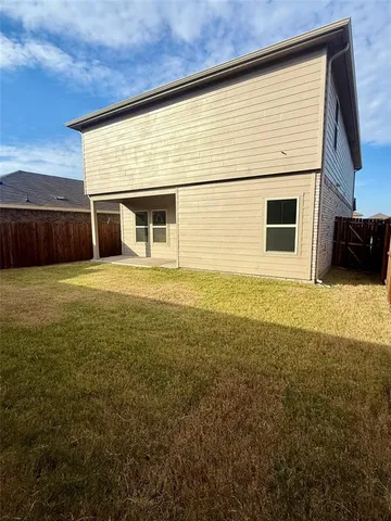 a view of house with backyard