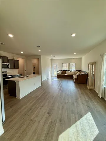 a view of kitchen with furniture and wooden floor