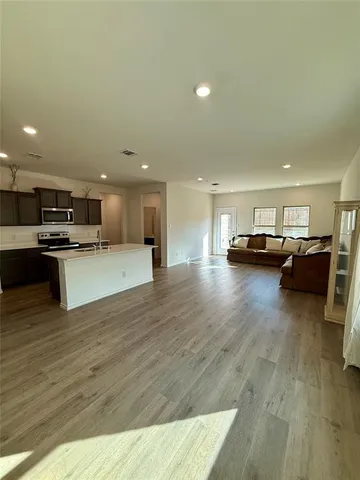 a view of kitchen with furniture and wooden floor