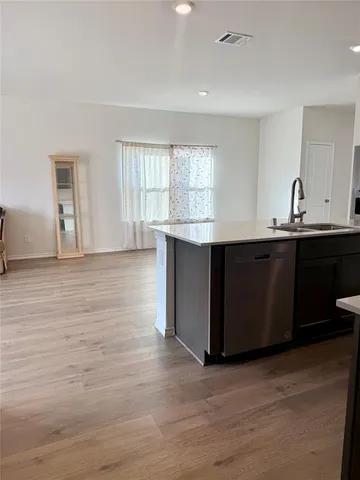a view of kitchen with cabinets and wooden floor