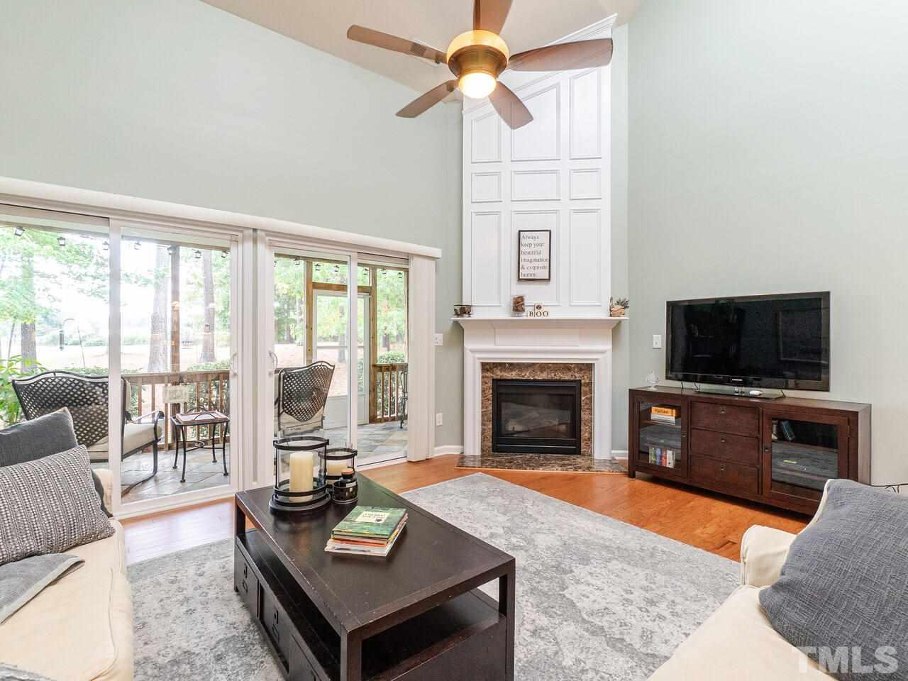 3901 Cathedral Bell Road Raleigh, NC 27614 - Photo 13 of 30 a living room with furniture a flat screen tv and a fireplace