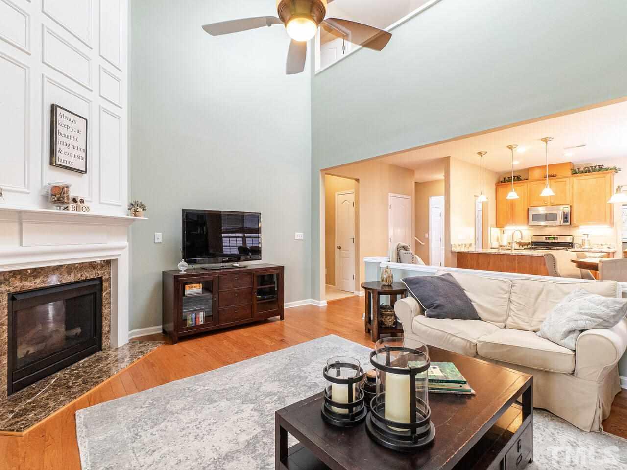 3901 Cathedral Bell Road Raleigh, NC 27614 - Photo 14 of 30 a living room with furniture flat screen tv and a fireplace