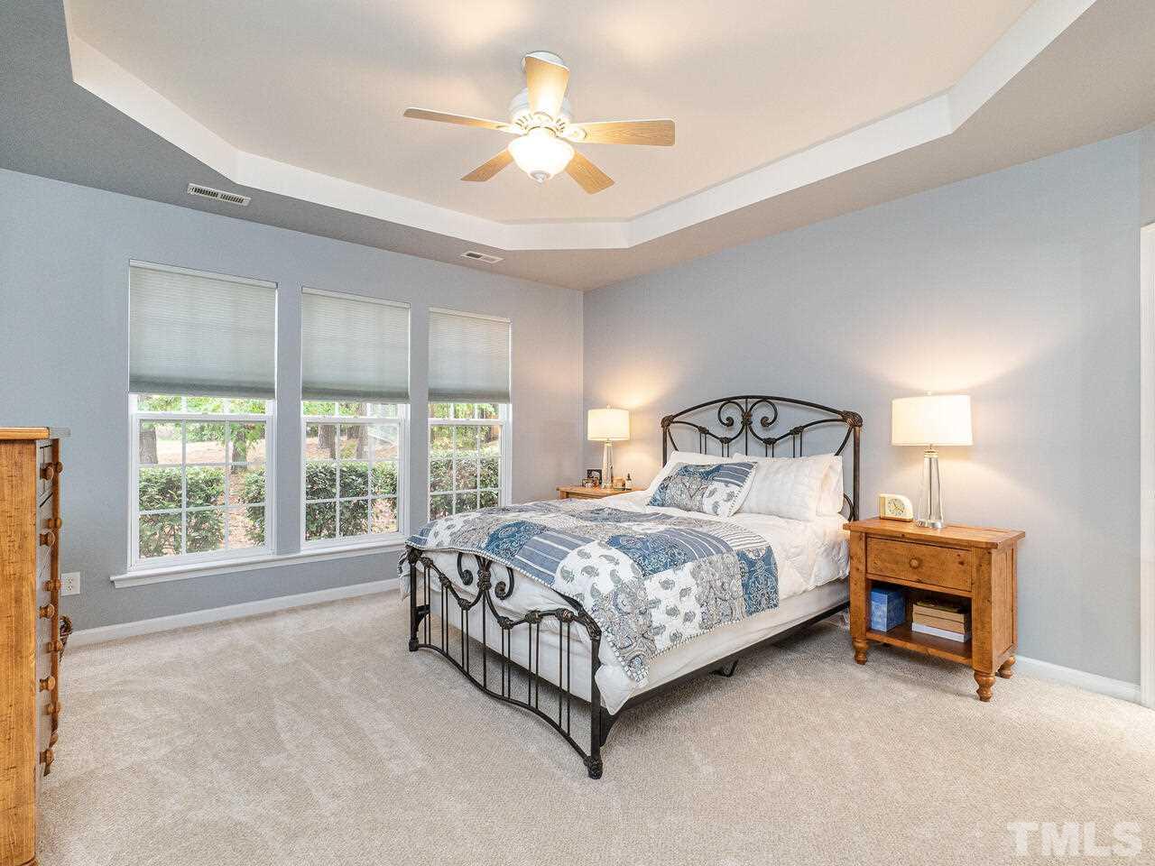 3901 Cathedral Bell Road Raleigh, NC 27614 - Photo 15 of 30 a bed sitting in a bedroom next to a window