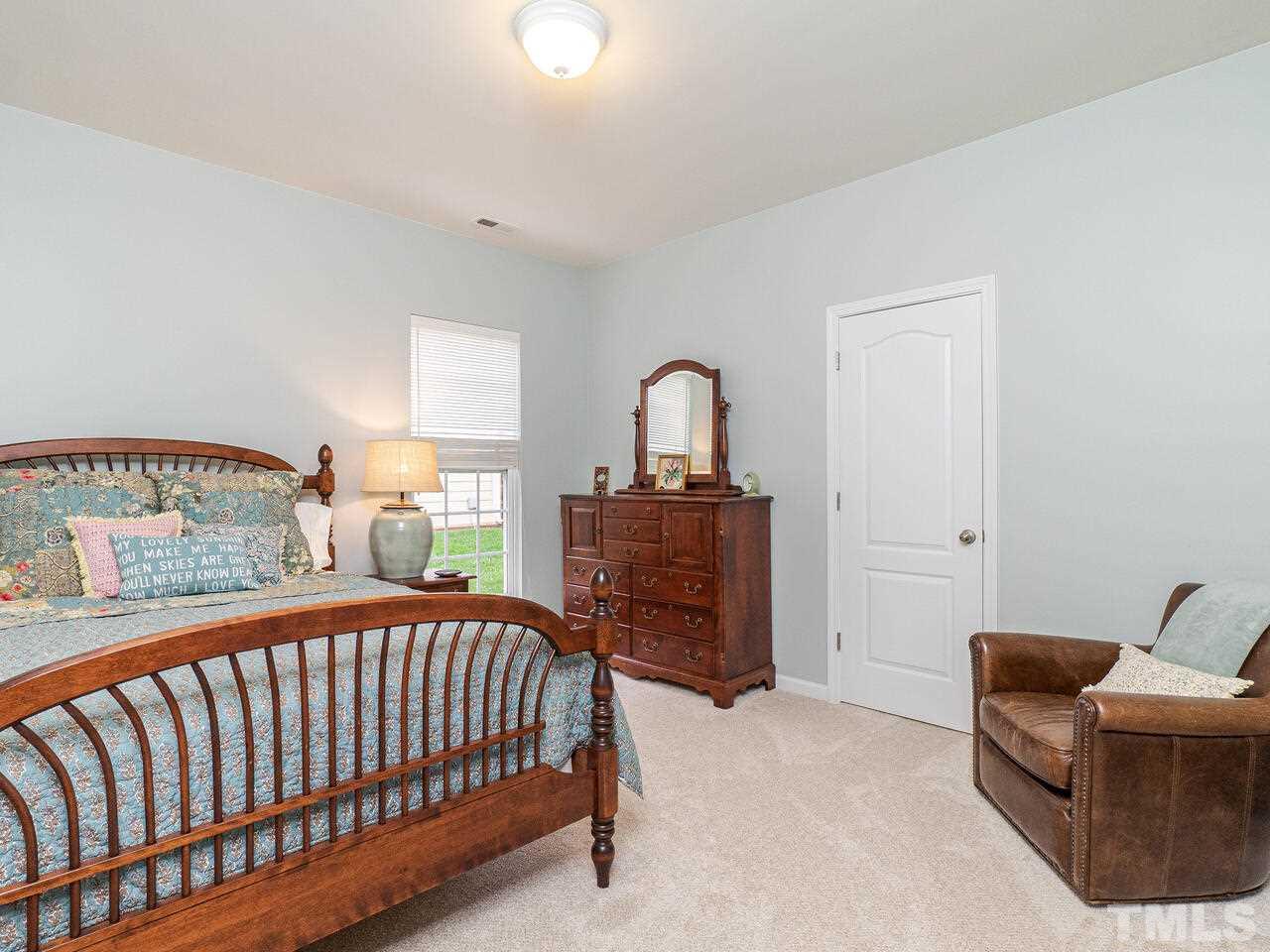 3901 Cathedral Bell Road Raleigh, NC 27614 - Photo 18 of 30 a bedroom with a bed and dresser