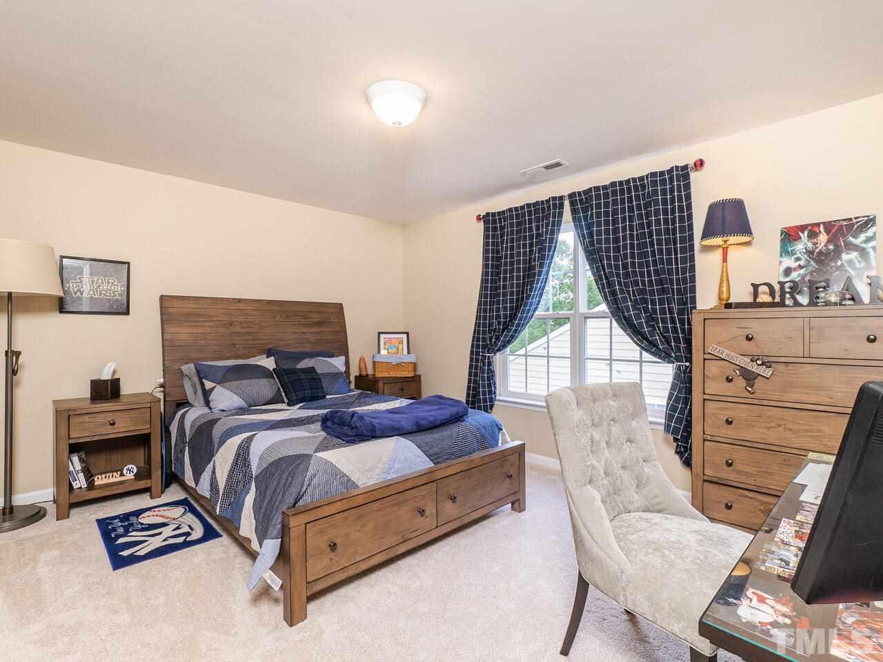3901 Cathedral Bell Road Raleigh, NC 27614 - Photo 19 of 30 a spacious bedroom with a bed a dresser and a closet