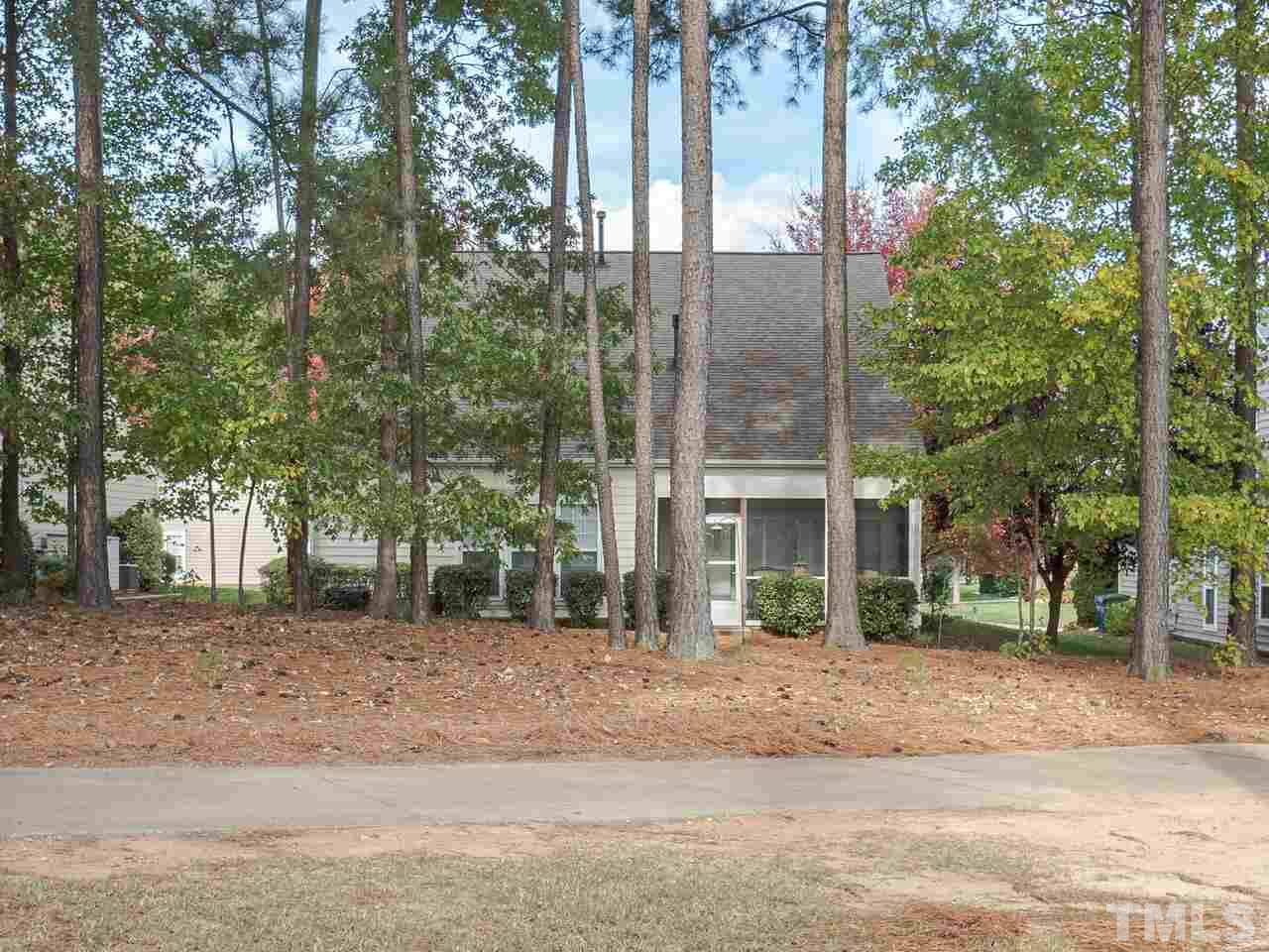 3901 Cathedral Bell Road Raleigh, NC 27614 - Photo 29 of 30 a view of a brick building next to a yard with large trees