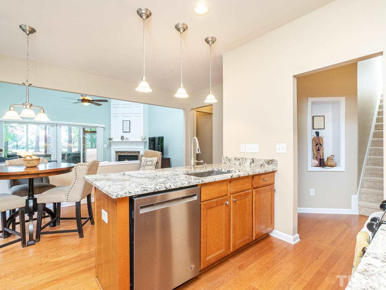 3901 Cathedral Bell Road Raleigh, NC 27614 - Photo 8 of 30 a kitchen with stainless steel appliances granite countertop a sink a stove and a wooden floors