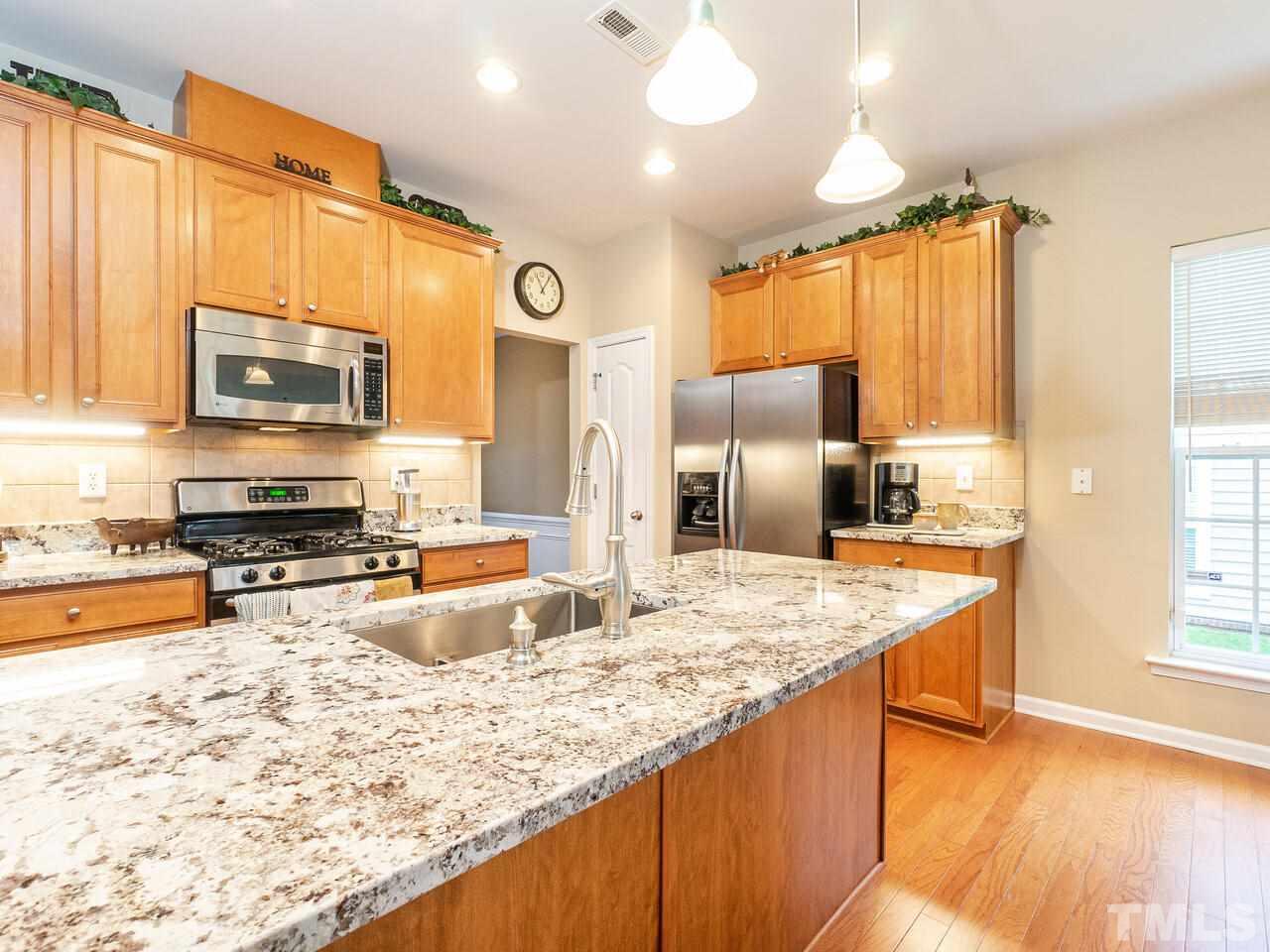 3901 Cathedral Bell Road Raleigh, NC 27614 - Photo 10 of 30 a kitchen with stainless steel appliances granite countertop a sink stove and refrigerator