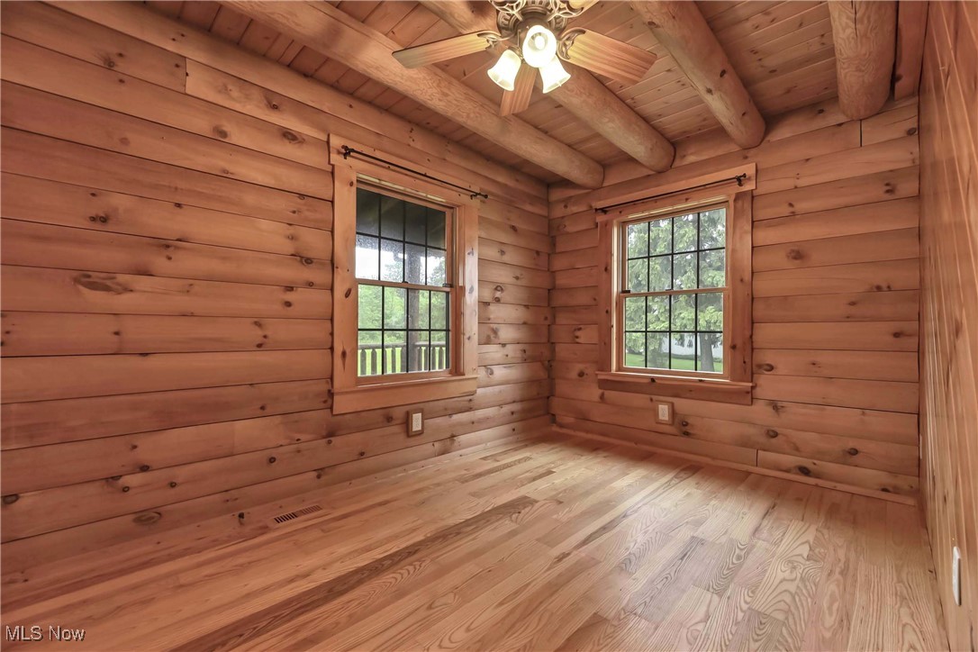 8164 Vandemark Road Lodi, OH 44254 - Photo 12 of 50 First floor guest bedroom with wood floors, walls and overhead ceiling fan and light