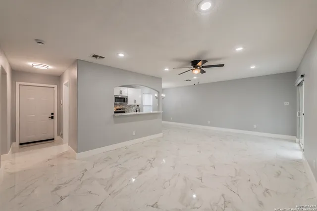 a view of a kitchen with a sink and a refrigerator