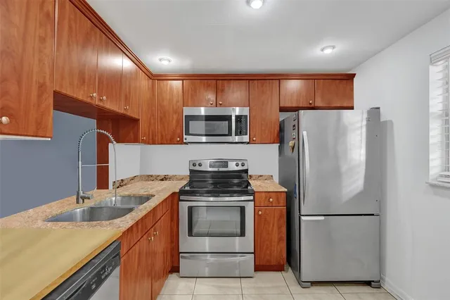 a kitchen with a sink stove and microwave