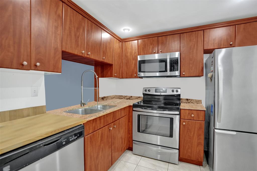 9235 Lagoon Place, Unit 207 Davie, FL 33324 - Photo 17 of 59 a kitchen with a sink stove and microwave
