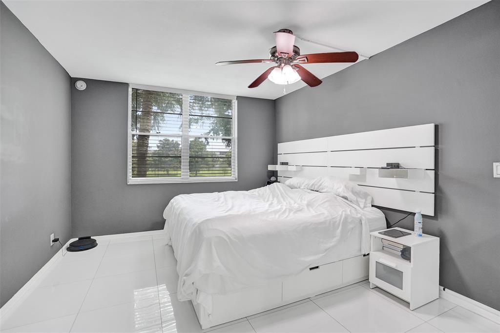 9235 Lagoon Place, Unit 207 Davie, FL 33324 - Photo 21 of 59 a bedroom with a bed and a chandelier