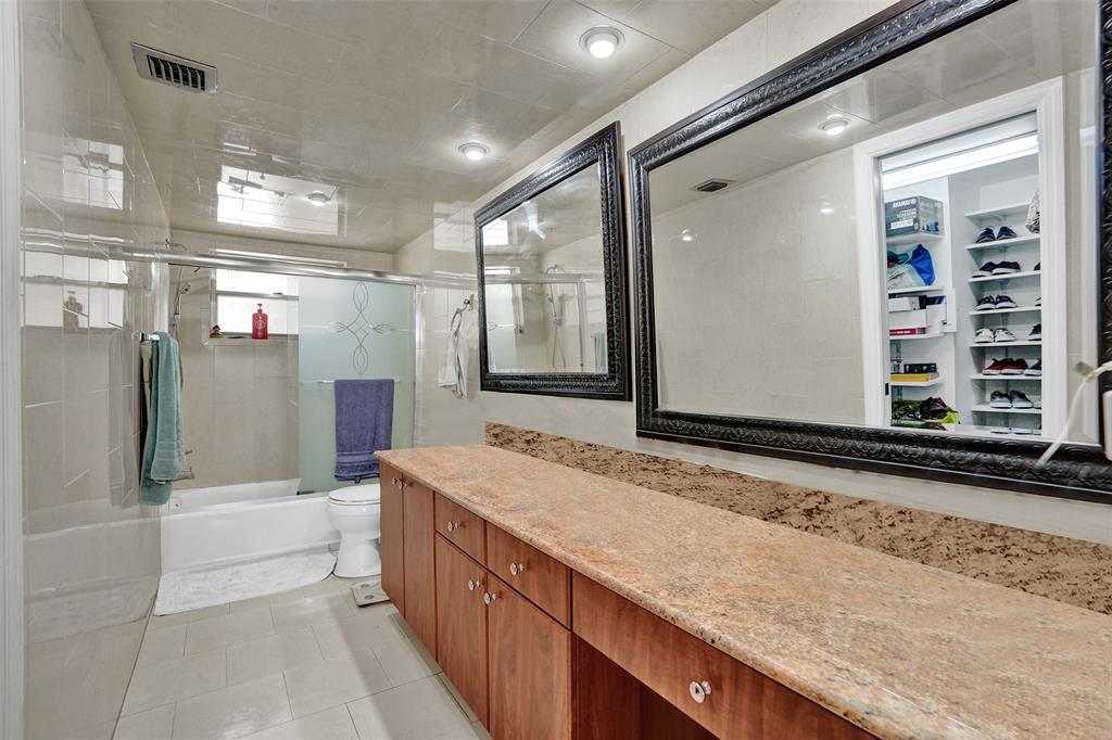 9235 Lagoon Place, Unit 207 Davie, FL 33324 - Photo 22 of 59 a bathroom with a granite countertop sink and mirror