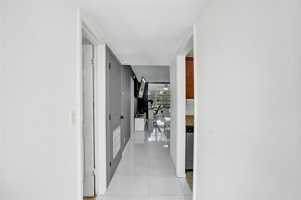 9235 Lagoon Place, Unit 207 Davie, FL 33324 - Photo 26 of 59 a view of a hallway with seating area