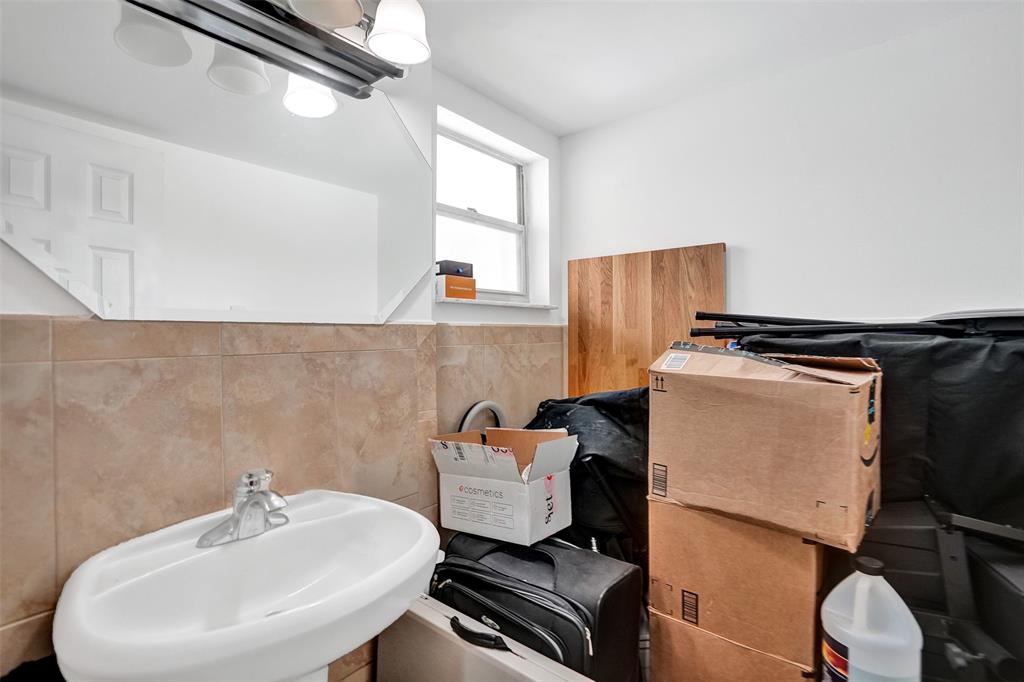 9235 Lagoon Place, Unit 207 Davie, FL 33324 - Photo 28 of 59 a bathroom with a sink and a mirror