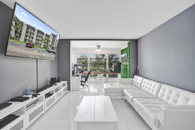 a living room with furniture and large windows