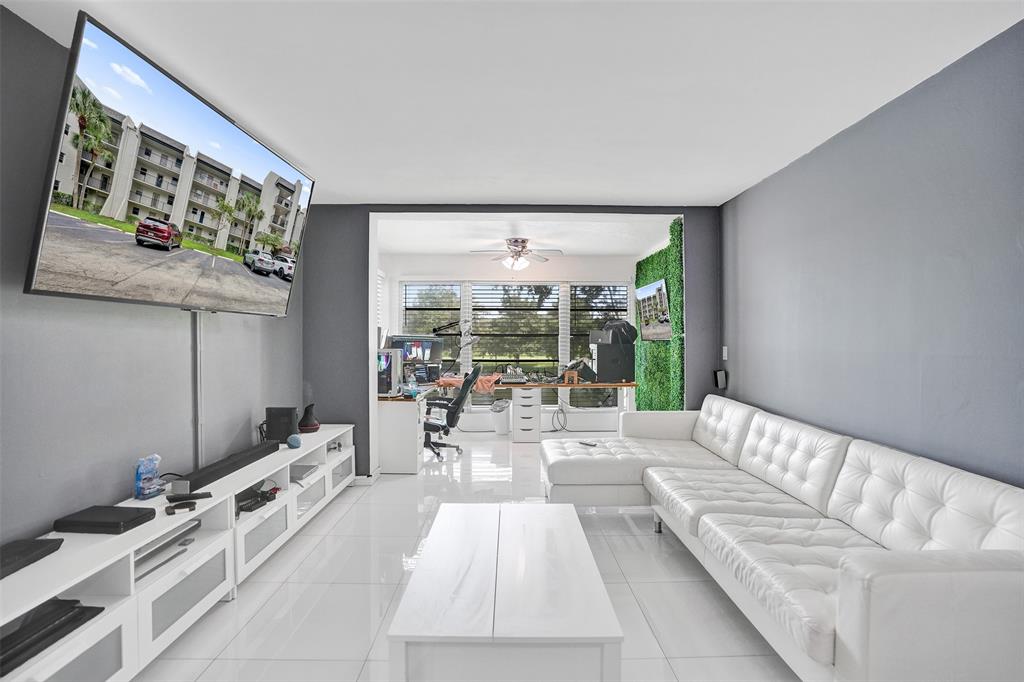 9235 Lagoon Place, Unit 207 Davie, FL 33324 - Photo 3 of 59 a living room with furniture and large windows