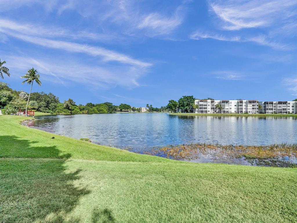 9235 Lagoon Place, Unit 207 Davie, FL 33324 - Photo 36 of 59 a view of a lake with a big yard