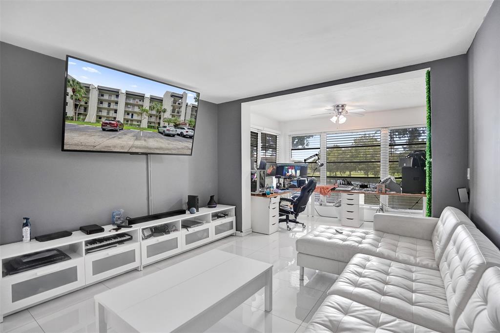 9235 Lagoon Place, Unit 207 Davie, FL 33324 - Photo 5 of 59 a living room with furniture and a large window