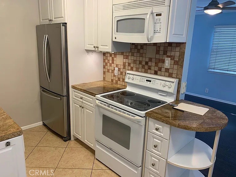 4401 Division Long Beach, CA 90803 - Photo 16 of 50 a kitchen with granite countertop a stove microwave and refrigerator