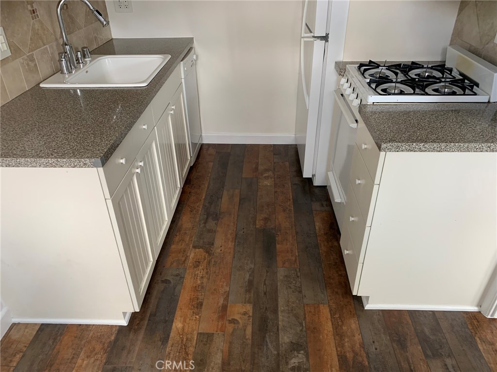 4401 Division Long Beach, CA 90803 - Photo 39 of 50 a kitchen with sink a stove and wooden floor