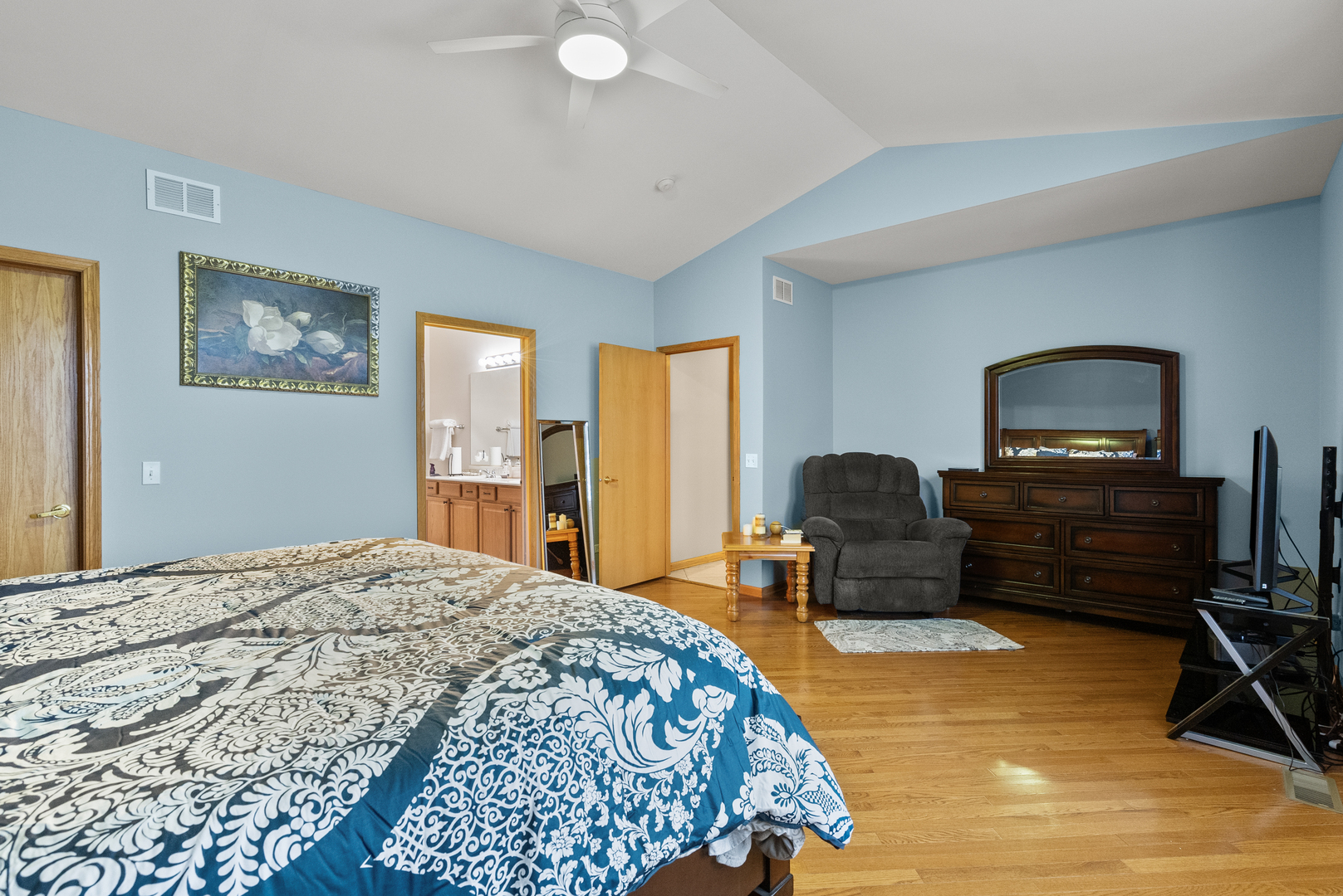 782 Baldwin Lane Romeoville, IL 60446 - Photo 13 of 39 a spacious bedroom with a bed and a dresser with a bookshelf
