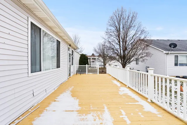 a view of backyard with large trees and wooden fence