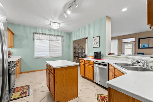 a kitchen with stainless steel appliances granite countertop a sink and a stove