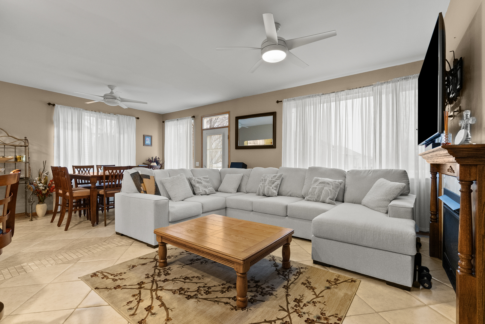 782 Baldwin Lane Romeoville, IL 60446 - Photo 10 of 39 a living room with furniture a large window and a flat screen tv