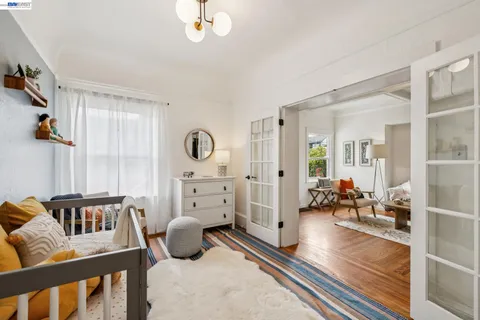 a view of a bedroom with furniture and wooden floor