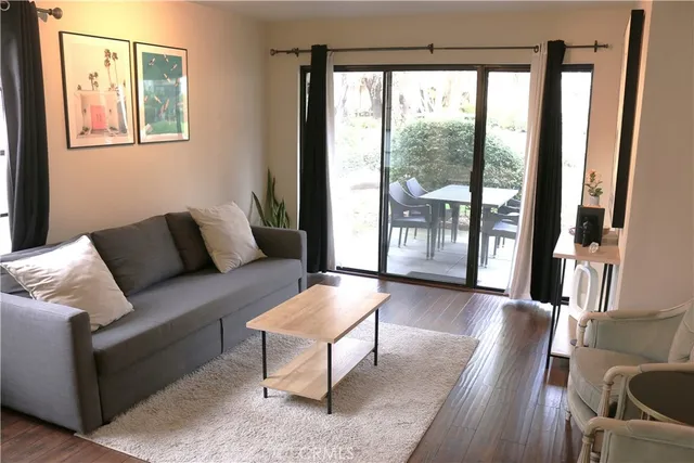 a view of front door with furniture and a window