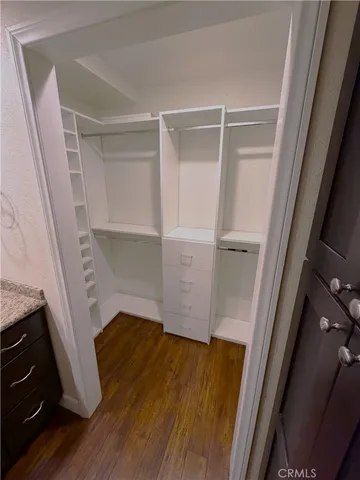 a view of walk in closet with empty racks