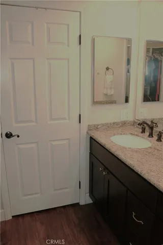 a bedroom with a bed and a night stand