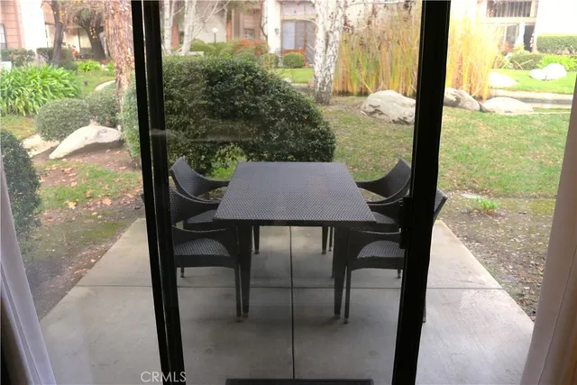 a view of a dinning table and chairs in patio