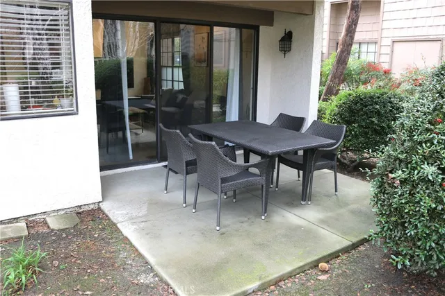a view of outdoor dining space with a table and chairs