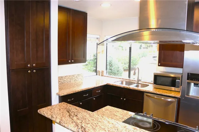 a kitchen with a sink and large window