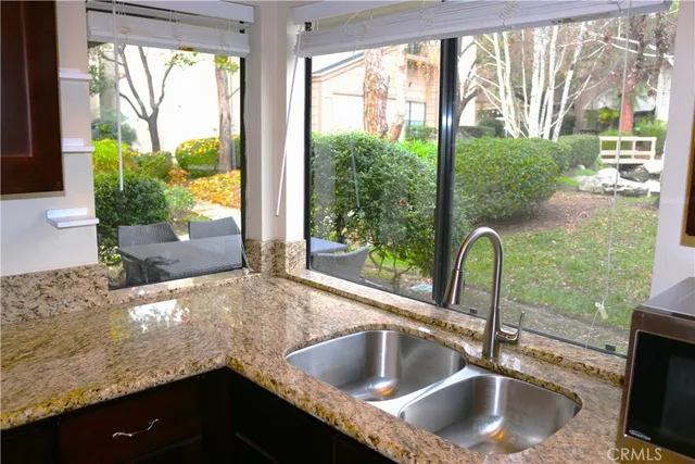 a kitchen with granite countertop a sink and a window