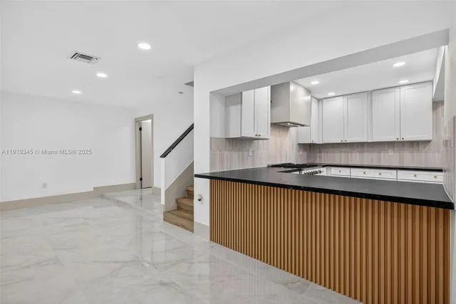 a view of kitchen and hall with wooden floor