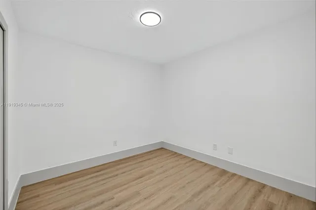 a bathroom with a toilet sink vanity and mirror