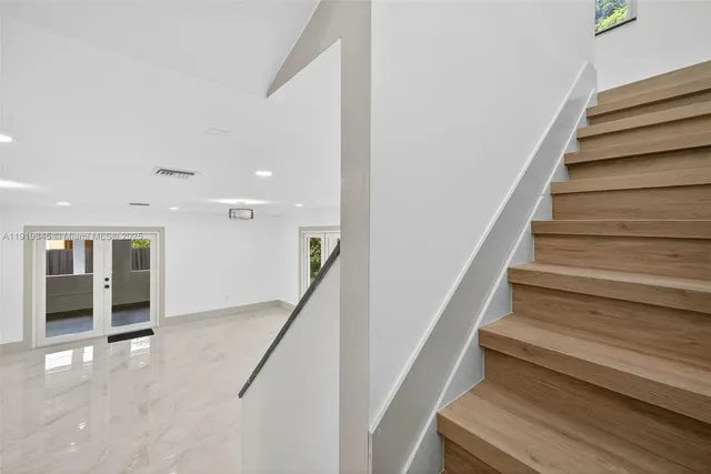 a bathroom with a tub sink toilet and mirror