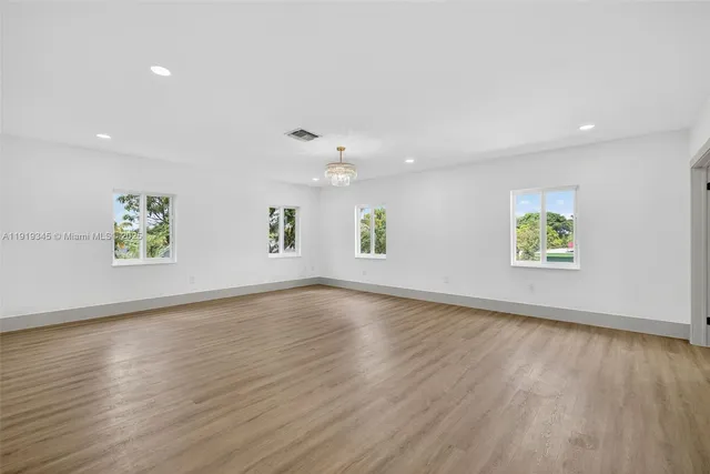 a spacious bathroom with a double vanity sink a mirror and a shower