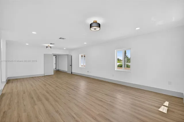 an aerial view of a house with garden space and street view