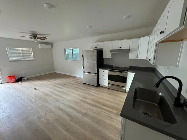 a kitchen with granite countertop a stove and a refrigerator