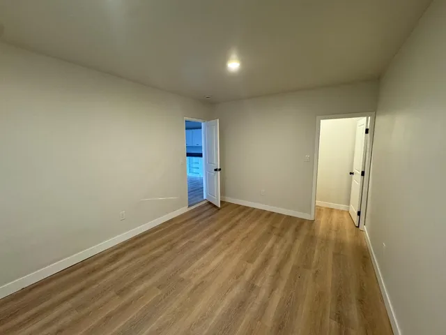 a view of an empty room and wooden floor