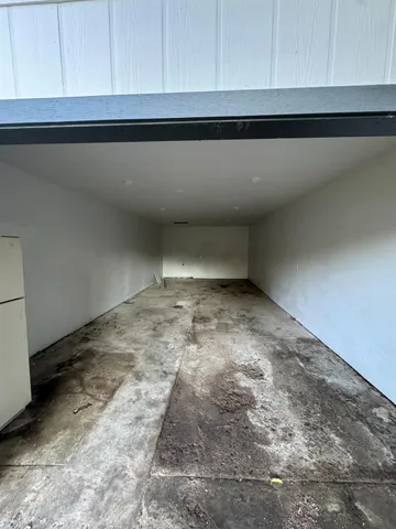 a view of a house with a backyard and a tree