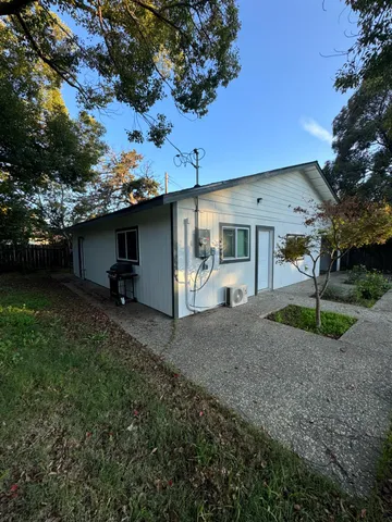 a backyard of a house with table and chairs