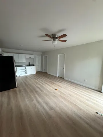 a view of an empty room with a ceiling fan