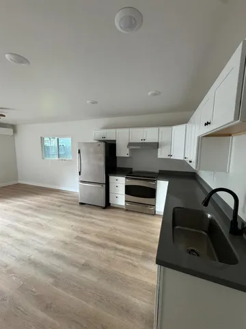 a kitchen with stainless steel appliances granite countertop a sink and stove