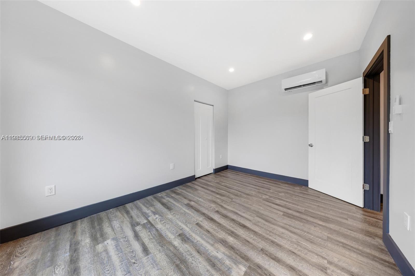 1020 Southwest 23rd Avenue, Unit 4 Miami, FL 33135 - Photo 12 of 17 a view of an empty room with wooden floor and a window